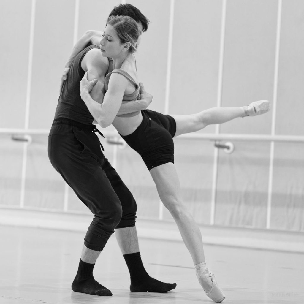 Melissa Panetta rehearsing a duet, supported by a partner mid-lift.